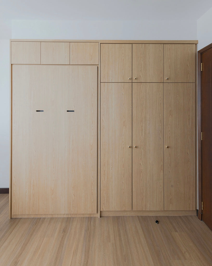 Murphy bed in super single size with wardrobe and cabinets to ceiling. Oak wood laminate finishing.